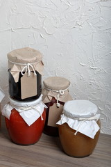 Homemade seasonal preparations. In banks, canned vegetables, fruits. The neck of the cans is...