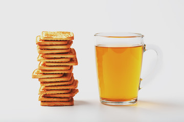 Wheat biscuits and a mug of green tea inside on a light background, soft contrast. Cookies are laid out in the breakfast room