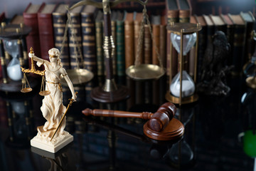 Fototapeta na wymiar Judge, justice concept background. Gavel, statue of justice and scale in the old university library.