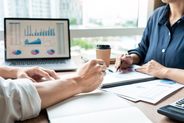 Teamwork concept, Business executives discussing document work at meeting in modern office lobby.