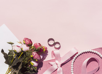 Flat lay pink wedding arrangement with pink background