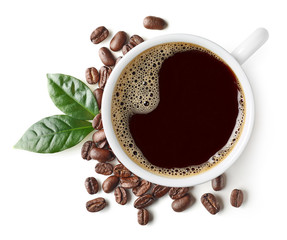 Cup of black coffee with beans and leaves