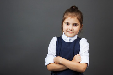 Portrait of a little girl in the school uniform going to school. Copy space. The concept of...