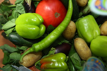 Assortment of fresh vegetables from Farmers market. Healthy food. Assorted fresh vegetables. On a black wooden background. View from above. Pepper, eggplant, cucumber .