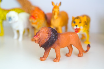 rubber lion on white background with clipping path . Brown Plastic Toy Lion on White Background .