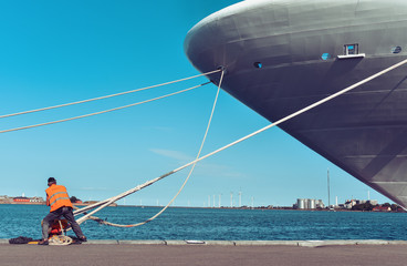 mooring of a large ship to the pier - obrazy, fototapety, plakaty