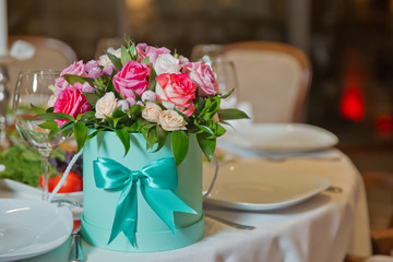 Beautiful bouquets of pink, white, yellow and red flowers in the round box . Red and purple flower bouquet in round green box .