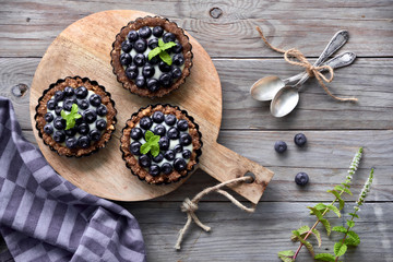 Flat lay of delicious Blueberry tartlets with vanilla custard