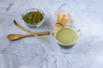 Matcha green tea with froth is a tasty way to enjoy energy and health benefits. Matcha is a green tea leaf powder filled with antioxidants. Horizontal orientation