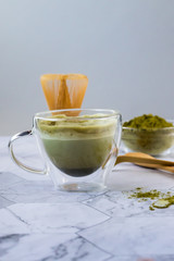 Matcha green latte tea with coconut milk. This latte is a tasty way to enjoy the energy and health benefits of a match. Matcha is a green tea leaf powder filled with antioxidants. Vertical orientation