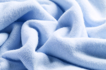 Knitted cashmere blue fabric texture with large fold - obrazy, fototapety, plakaty