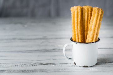 Churros, a traditional Spanish sweet food pastry dessert, on white background