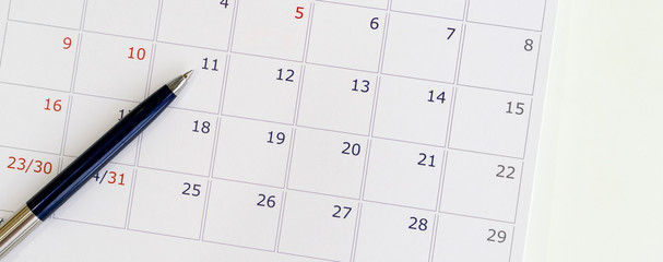 close up top view of calendar at desk for business event date concept