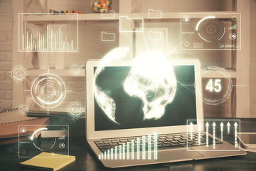 Double exposure of chart and financial info and work space with computer background. Concept of international online trading.