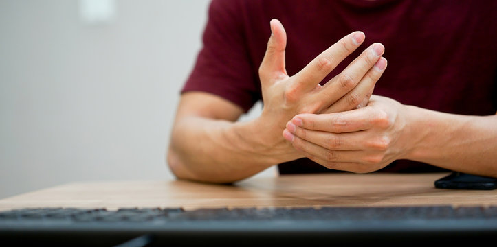 close up employee man massage on his hand and arm for relief pain from hard working ,carpal tunnel syndrome concept	
