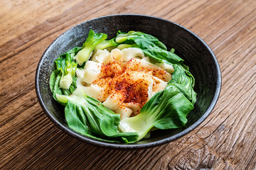 A bowl of nutritious and delicious oily noodles on a wooden tabletop