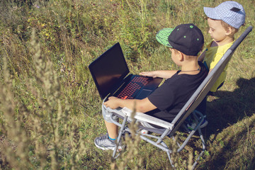 two little boys working on laptop