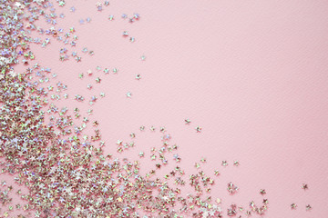 Golden stars glitter on pink background. Flat lay