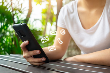 Asian woman hand using smartphone to contact with email, message and call icon in casual day off, customer service concept