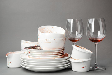 Set of dirty dishes on grey background