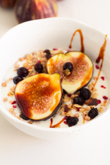 breakfast cereal with fig yogurt and berries close-up