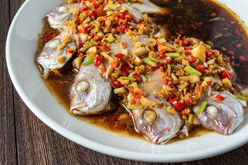 Chinese cuisine chili steamed red squid on wooden board background