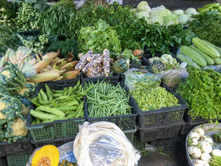 Various kinds of vegetable display in plastic baskets at fresh market