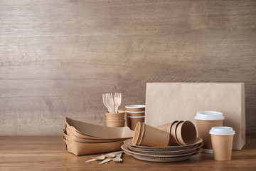 New paper dishware on wooden table, space for text. Eco life