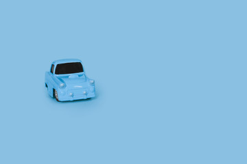 blue retro toy car on an isolated blue background