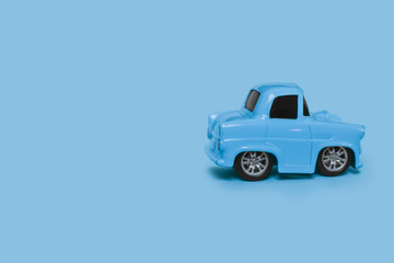 blue retro toy car on an isolated blue background