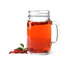 Healthy goji juice in mason jar with berries on white background