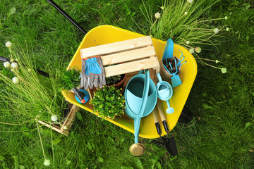 Composition with gardening tools on green grass, above view