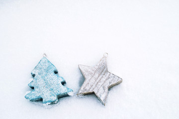 Fototapeta na wymiar Christmas wooden toys christmas tree and star on snow in winter, christmas decoration