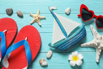 Flat lay composition with stylish beach accessories on light blue wooden background