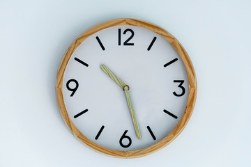 trditional clock on white wall background isolated