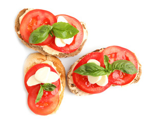 Tasty fresh tomato bruschettas on white background, top view