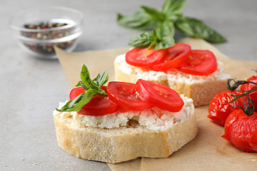 Tasty fresh tomato bruschettas on grey table