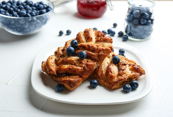 Fresh delicious puff pastry with sweet berries served on grey table