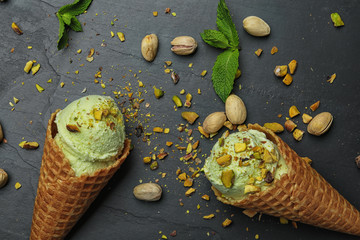 Delicious pistachio ice cream on dark table, flat lay