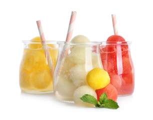 Glass jars of melon and watermelon ball cocktails on white background