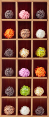 Various chocolate candy in wooden box.