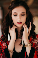 Portrait of beautiful young brunette woman with makeup in bright clothing