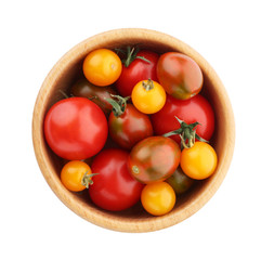 Ripe red and yellow tomatoes in wooden bowl on white background, top view