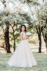 Beautiful brunette bride with stylish make-up in white dress