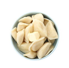 Delicious cooked dumplings in bowl on white background, top view