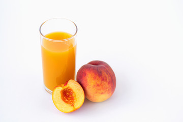 glass of peach juice and fresh fruits isolated on white
