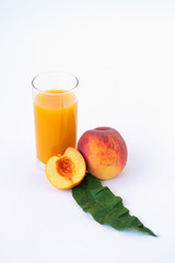 glass of peach juice and fresh fruits isolated on white background
