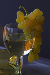 Grapes, white wine and glass