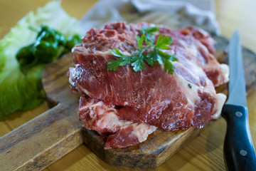 fresh veal chop meat on wood