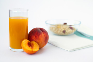 glass of peach juice and fresh fruits with cornflakes isolated on white background